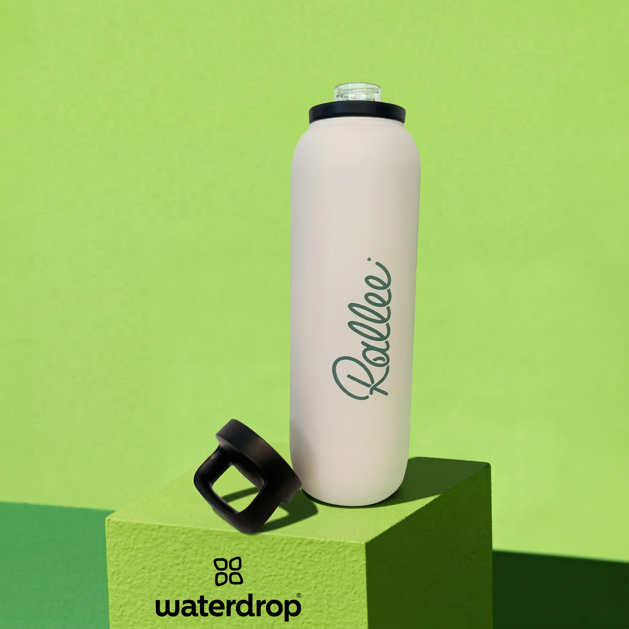White waterdrop bottle with black cap on a green platform, featuring the 'Rallee' brand.
