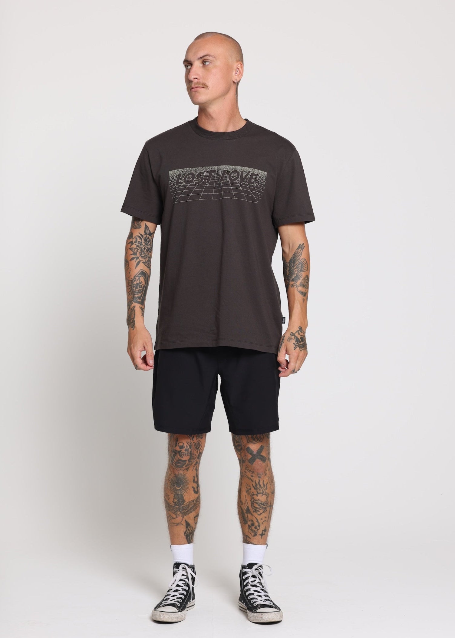 Man wearing vintage black ‘Love Lost’ tee with butter yellow print on front.