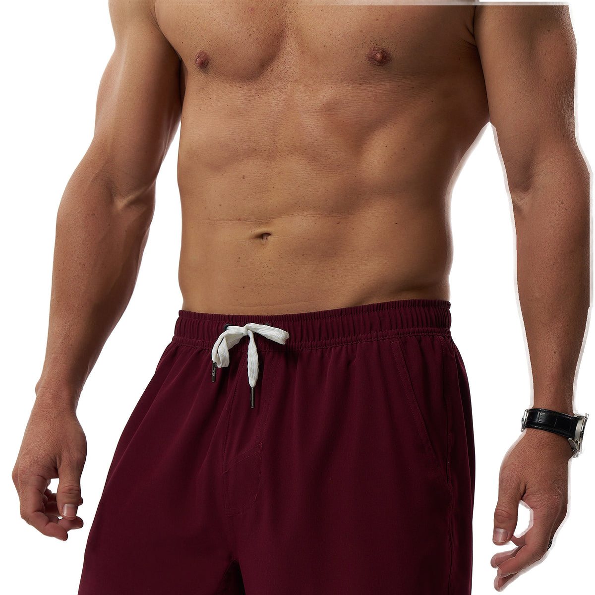 A close-up of a man's torso wearing burgundy athletic shorts with a white drawstring, shown against a plain white background.