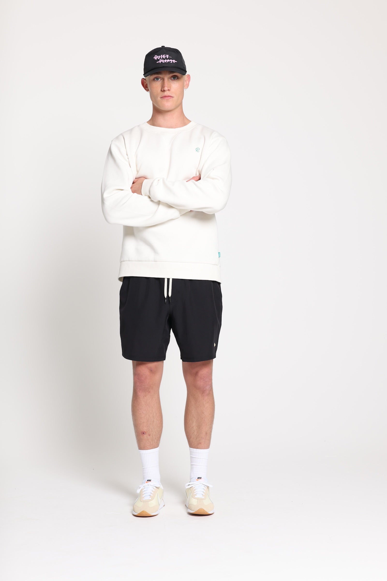 Man stands wearing Rallee Bigalow crew, in vintage white 