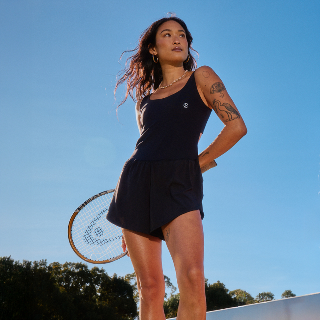 Woman in black Rallee Courtsie foliding a tennis racket