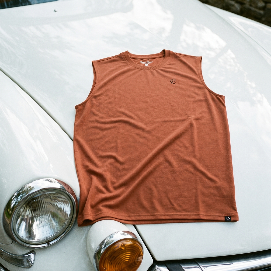 Clay coloured sleeveless tank on a white car with a blurred natural background