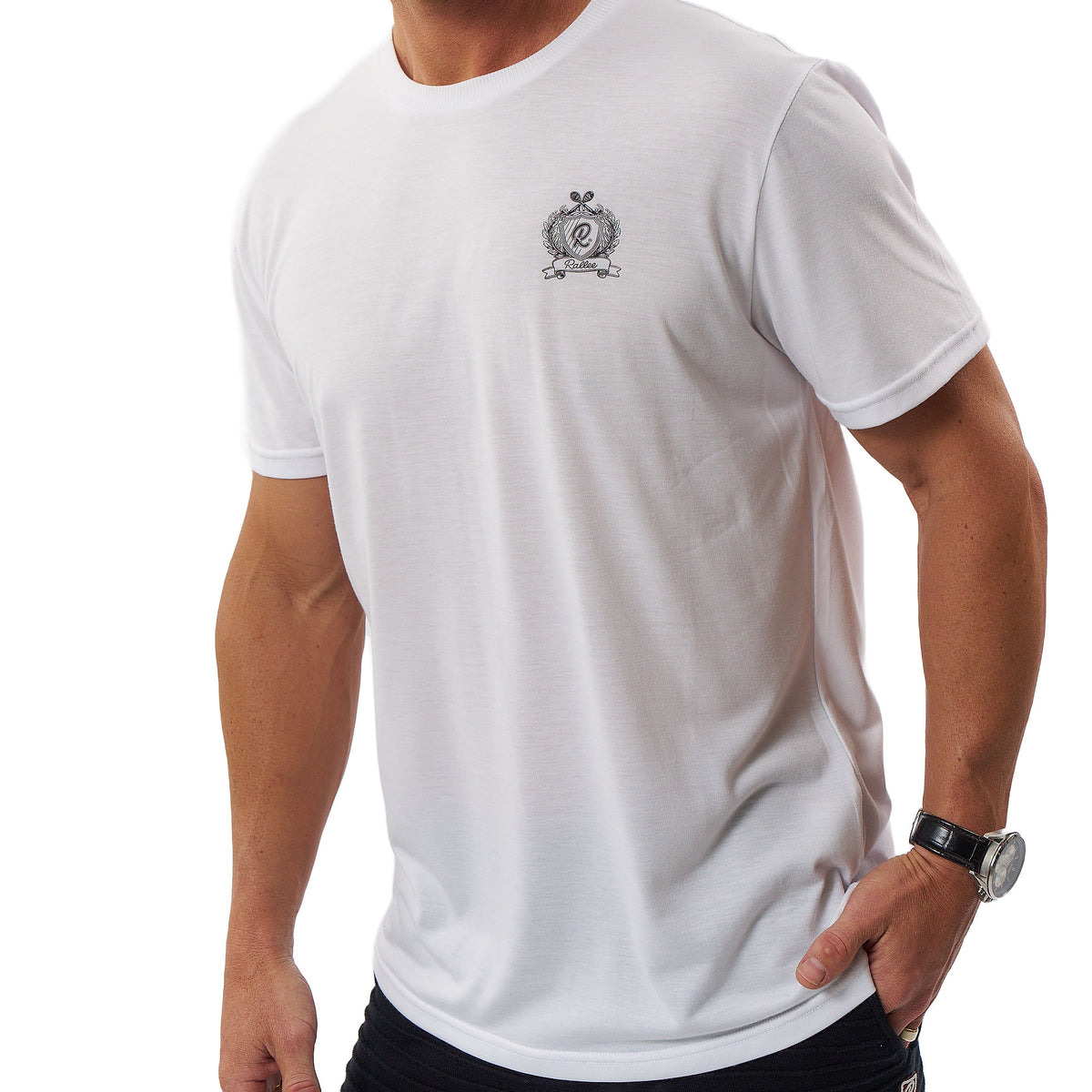 A man wearing a white short-sleeve crewneck t-shirt with a small gray crest logo on the left chest, shown from the neck down against a white background.